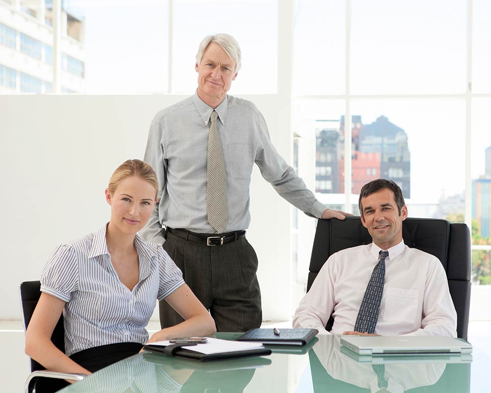 family-members-pose-in-a-conference-room A father meets with his children in a conference room of the family enterprise